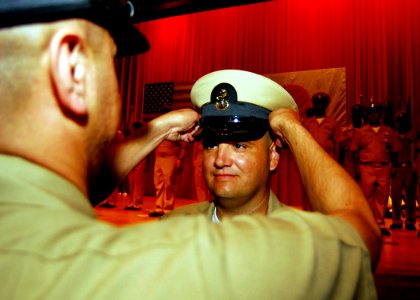 US Navy 080916-N-2013O-003 Chief Aviation Boatswain's Mate (Handling) Edward Rodrigues is presented his chief petty officer (CPO) combination cover