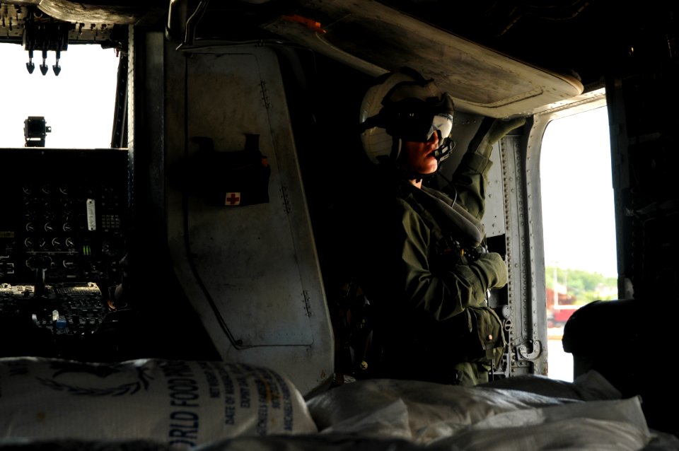 US Navy 080917-N-8907D-298 Sgt. Jayson Smith prepares for take off after loading food supplies