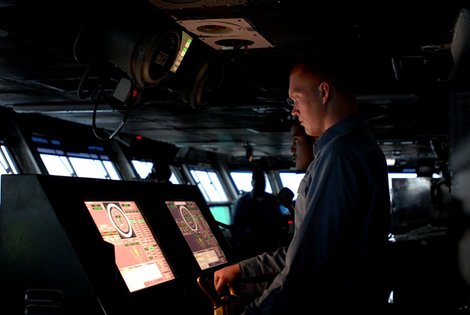 US Navy 080918-N-4995K-052 Boatswains Mate Seaman Corey Enss steers four acres of U.S. sovereign territory through the Gulf of Oman. Enss is standing master helmsman watch on the bridge of the Nimitz-class aircraft carrier USS