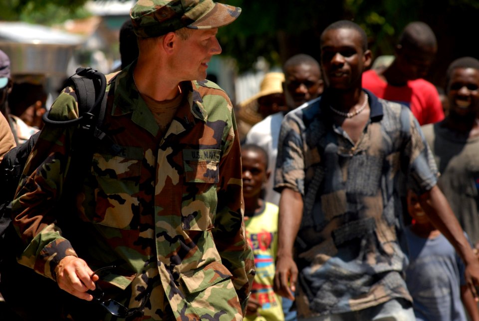 US Navy 080918-N-3595W-506 Capt. Tim Shope, assigned to the amphibious assault ship USS Kearsarge (LHD 3), speaks with locals while walking to the City Center in Belle Anse