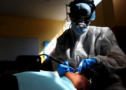 US Navy 110501-N-QD416-037 Hospital Corpsman 1st Class Kimberly Edwards, from Louisville, Ky., performs a deep cleaning on the teeth of a Peruvian photo