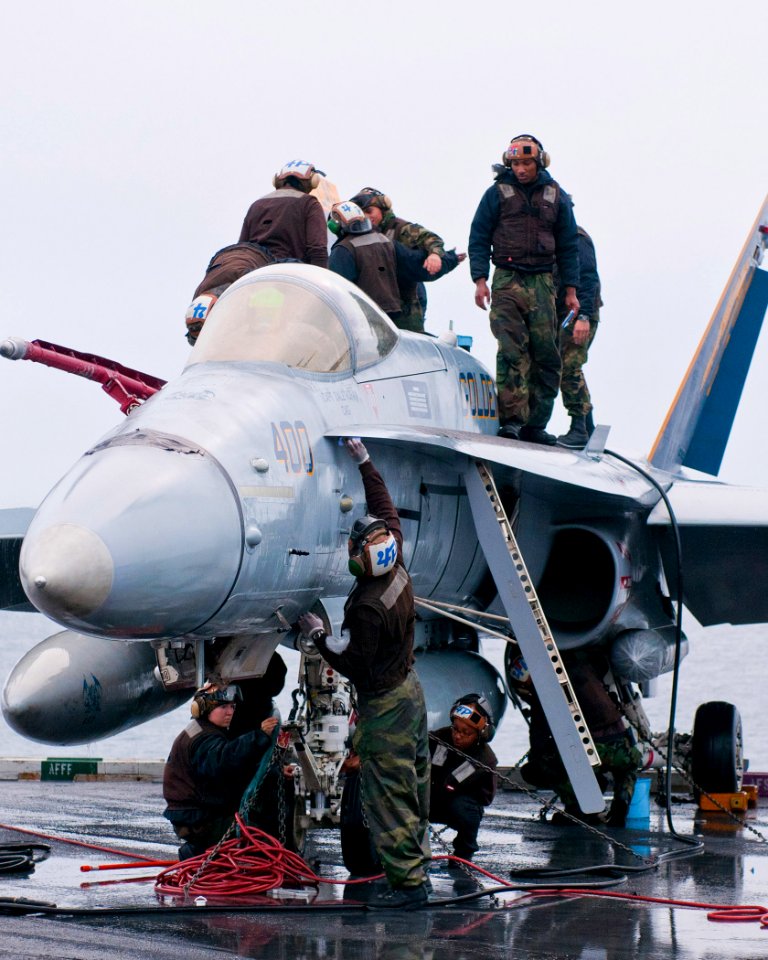 US Navy 110513-N-BT887-003 Sailors wash an F-A-18C Hornet from the