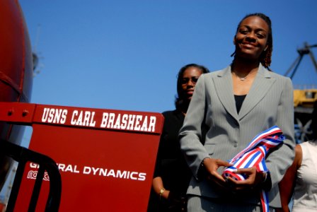US Navy 080918-N-9818V-232 Ms. Lauren E. Brashear, ships sponsor for USNS Carl Brashear (T-AKE 7) holds a ceremonial bottle of champagne before christening the ship