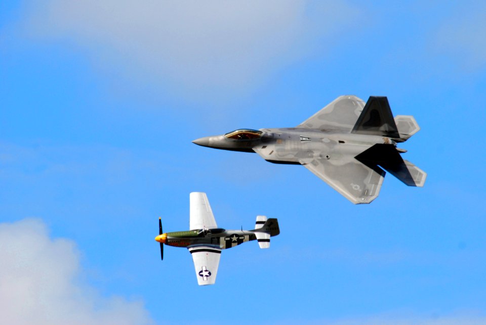 US Navy 080921-N-4469F-019 The United States Air Force Heritage Flight performs with the World War II P-51 Mustang and the state-of-the-art F-22 Raptor