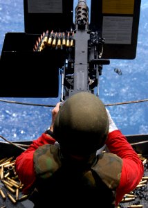 US Navy 080919-N-1038M-111 Lt. Cmdr. Matthew Roberts, USS George Washington's (CVN 73) Ordnance Handling Officer, shoots .50 caliber machine gun during a live fire training exercise