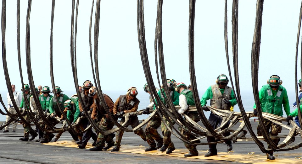 US Navy 080919-N-4995K-109 Sailors aboard the Nimitz-class aircraft carrier USS Ronald Reagan (CVN 76) set the training barricade during flight deck drills photo