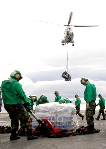US Navy 080917-N-7282P-057 Sailors move cargo on the flight deck of the aircraft carrier USS George Washington (CVN 73)