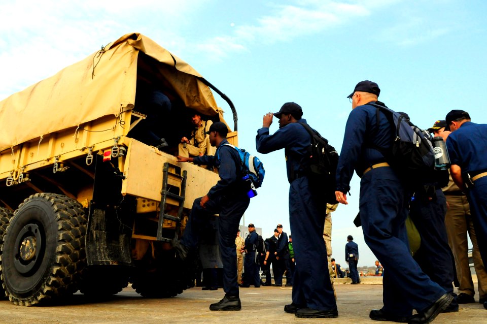 US Navy 080919-N-5758H-036 Sailors assigned to the amphibious assault ship USS Nassau (LHA 4) climb in the back of a MK28 cargo truck in Galveston, Texas to help provide relief aid to local citizens