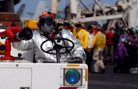 US Navy 080919-N-4995K-126 A Sailor from the crash and salvage team aboard the Nimitz-class aircraft carrier USS Ronald Reagan (CVN 76) fans the fire hose on the crash cart during flight deck drills photo
