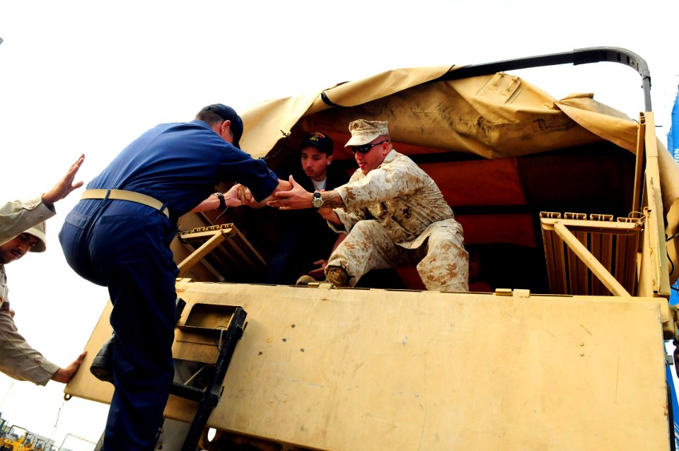 US Navy 080919-N-5758H-046 Gunnery Sgt. William Ward helps Sailors from the amphibious assault ship USS Nassau (LHA 4) board a MK28 cargo truck in Galveston, Texas to help provide relief aid to local citizens