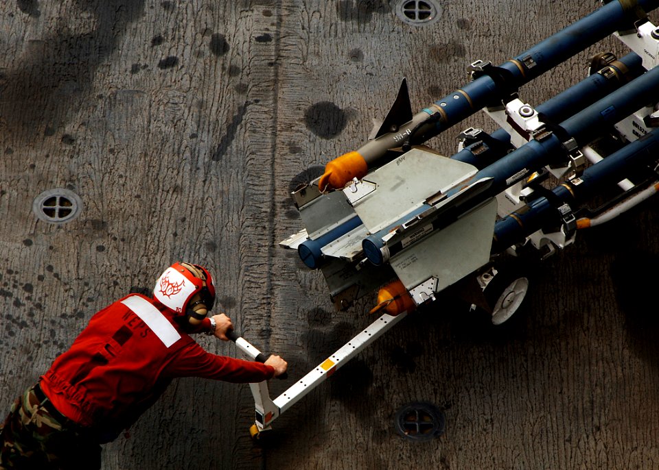 US Navy 080920-N-4236E-143 An Aviation Ordnanceman moves ordnance across the flight deck of the multi-purpose amphibious assault ship USS Iwo Jima (LHD 7)