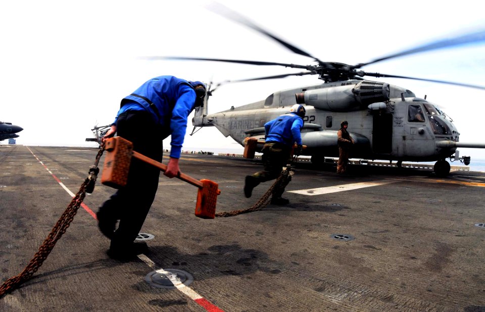 US Navy 110508-N-7508R-003 Aviation boatswain's mates (handling) aboard the multipurpose amphibious assault ship USS Bataan (LHD 5) prepare to secu