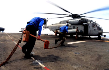 US Navy 110508-N-7508R-003 Aviation boatswain's mates (handling) aboard the multipurpose amphibious assault ship USS Bataan (LHD 5) prepare to secu