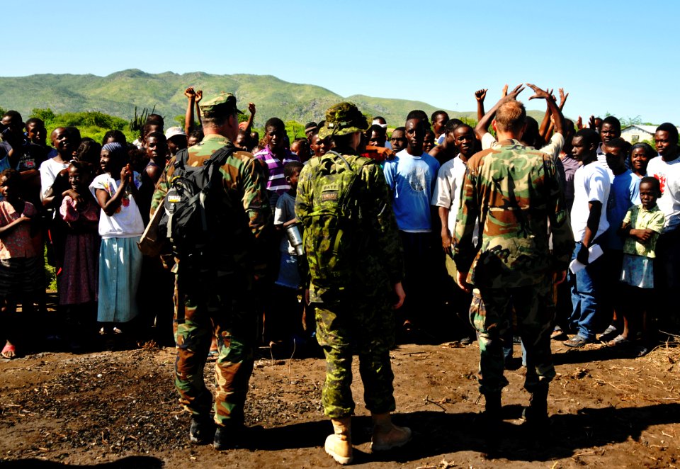 US Navy 080918-N-8907D-002 Personnel embarked aboard the amphibious assault ship USS Kearsarge (LHD 3) are cheered by Haitian civilians during a hurricane recovery mission