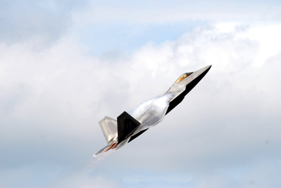US Navy 080921-N-4469F-016 The speed of the F-22 Raptor generates vapor over the wings as it demonstrates its climb capabilities during the 50th Anniversary Naval Air Station Oceana Air Show