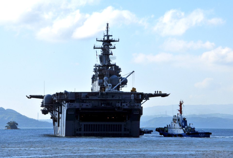 US Navy 080919-N-0807W-418 The amphibious assault ship USS Essex (LHD 2) is pulled by tugs from her berth as she departs for a scheduled deployment