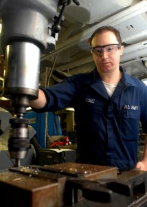 US Navy 080923-N-2456S-055 Machinery Repairman Fireman Rob Conz uses a mill to drill a hole