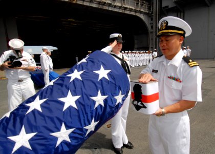 US Navy 080921-N-9079D-053 Lt. Peter T. Le, from Lockport, La., commits ashes to the deep during a burial-at-sea aboard the aircraft carrier USS Abraham Lincoln (CVN 72)