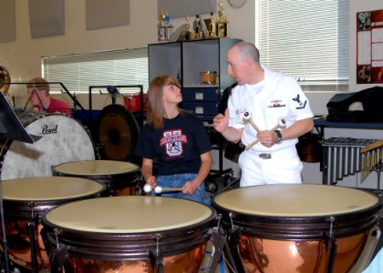 US Navy 080923-N-4649C-003 Storekeeper 3rd Class Stephen Hux gives pointers on playing the timpani to a student from McNary High School photo