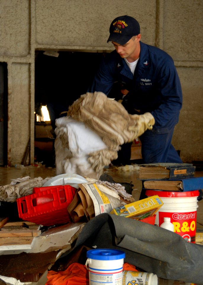US Navy 080922-N-2838W-019 Machinist Mate 3rd Class James Brown helps remove debris from the Galveston Flight Museum after Hurricane Ike