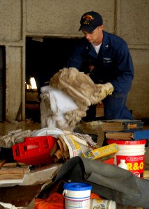 US Navy 080922-N-2838W-019 Machinist Mate 3rd Class James Brown helps remove debris from the Galveston Flight Museum after Hurricane Ike
