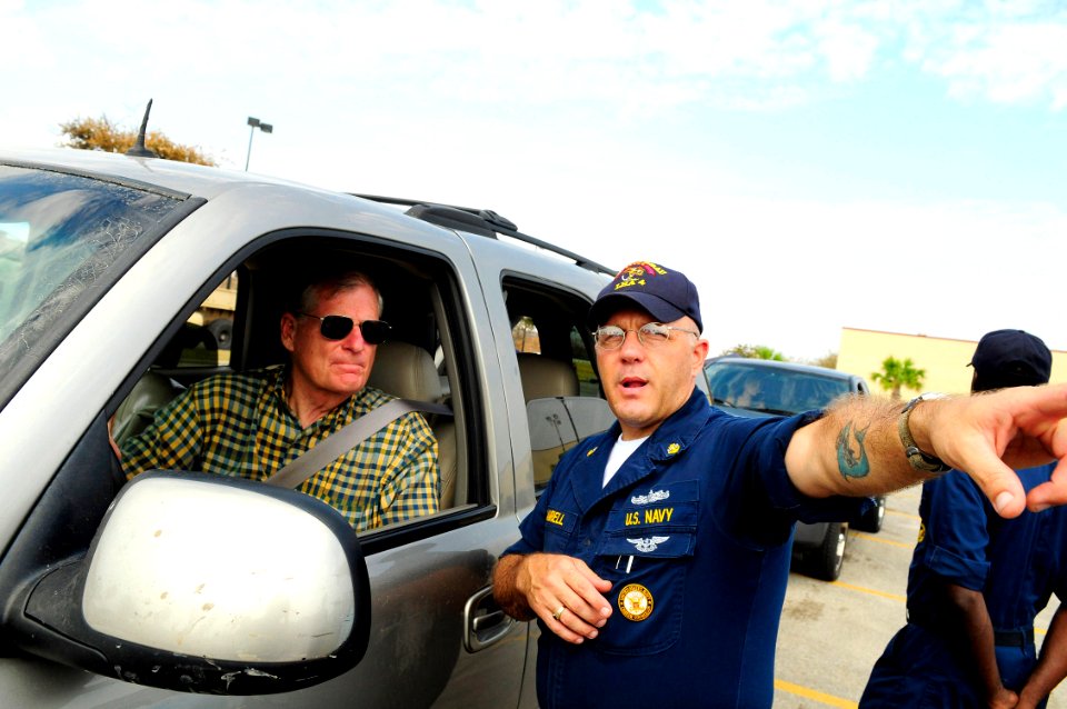 US Navy 080919-N-5758H-358 Chief Navy Career Counselor Ron Campbell, assigned to the amphibious assault ship USS Nassau (LHA 4), directs a Galveston, Texas resident to a Federal Emergency Management Agency (FEMA) tent at an aid