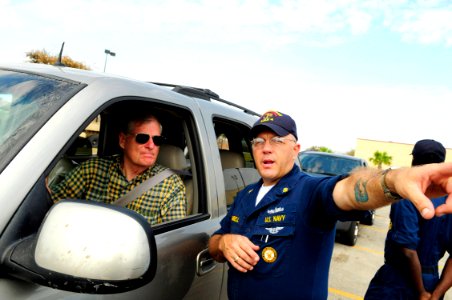 US Navy 080919-N-5758H-358 Chief Navy Career Counselor Ron Campbell, assigned to the amphibious assault ship USS Nassau (LHA 4), directs a Galveston, Texas resident to a Federal Emergency Management Agency (FEMA) tent at an aid