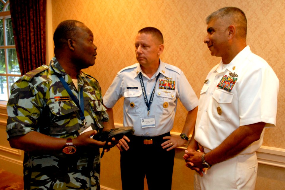 US Navy 080923-N-9818V-096 Kenyan Defense Sgt. Major, Warrant Officer 1 Ashford Miriti Ndubi talks with Master Chief Petty Officer of the Coast Guard Skip Bowen and Master Chief Petty Officer of the Navy (MCPON) Joe R. Campa Jr