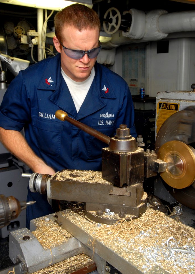 US Navy 080923-N-2456S-051 Machinery Repairman 2nd Class Bryan Gilliam uses a Lathe to make a new flange