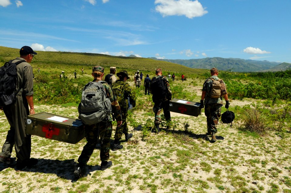 US Navy 080920-N-4515N-120 Military members from the U.S. and Canada embarked aboard the amphibious assault ship USS Kearsarge (LHD 3) carry medical supplies into a remote village in Haiti photo