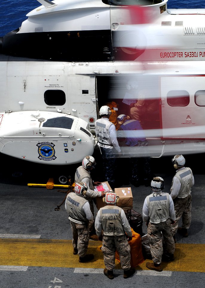 US Navy 110307-N-4743B-069 Marines unload mail from a SA330J Puma helicopter during an underway replenishment aboard USS Essex (LHD 2)