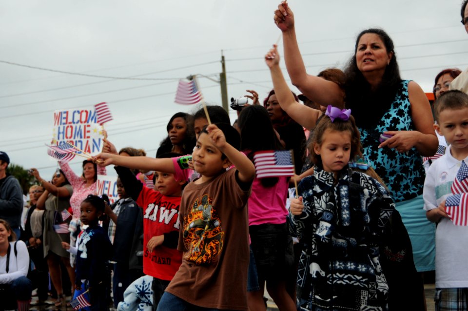 US Navy 110405-N-DD445-009 Family and friends wave flags and cheer as USS Doyle (FFG 39) pulls into Naval Station Mayport after retuning from a si