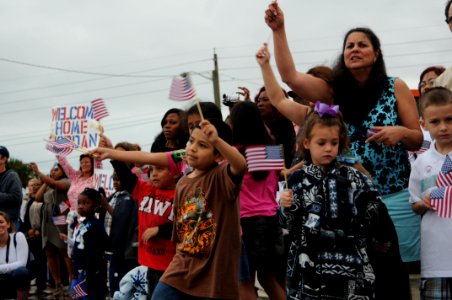US Navy 110405-N-DD445-009 Family and friends wave flags and cheer as USS Doyle (FFG 39) pulls into Naval Station Mayport after retuning from a si