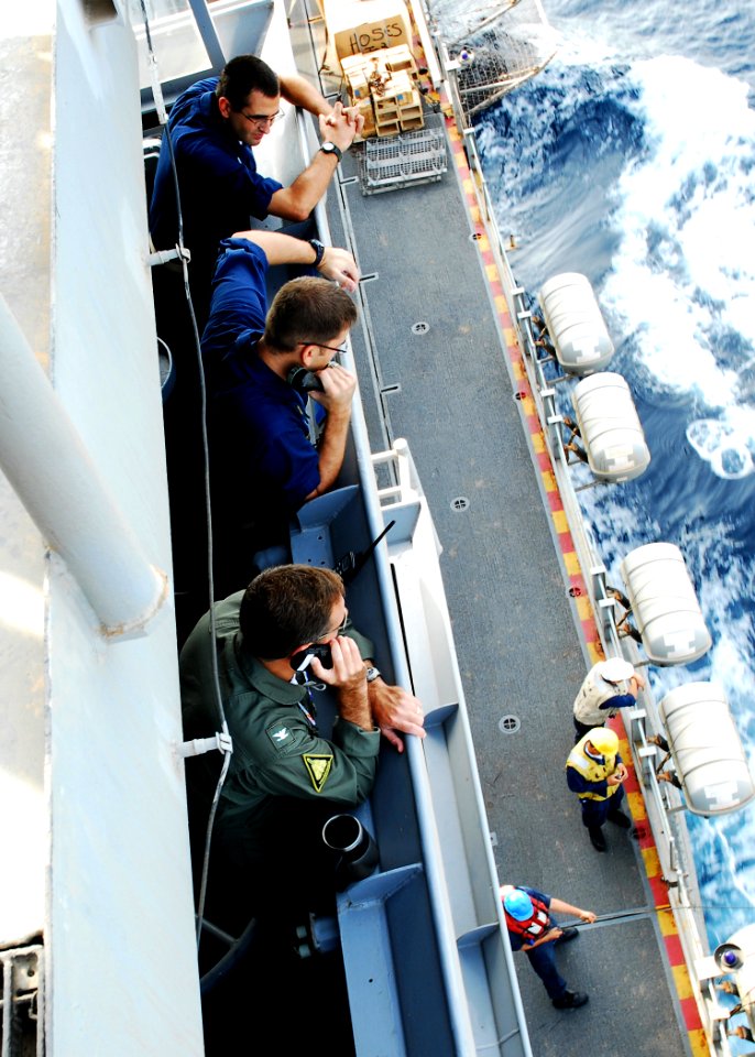 US Navy 080923-N-2183K-028 Capt. Marcus A. Hitchcock, commanding officer of the amphibious assault ship USS Peleliu (LHA 5), supervises an underway replenishment from the ship's bridge