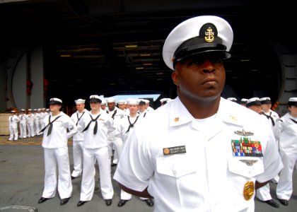 US Navy 080921-N-9079D-009 Senior Chief Master-at-Arms Lester L. Longley stands at parade rest