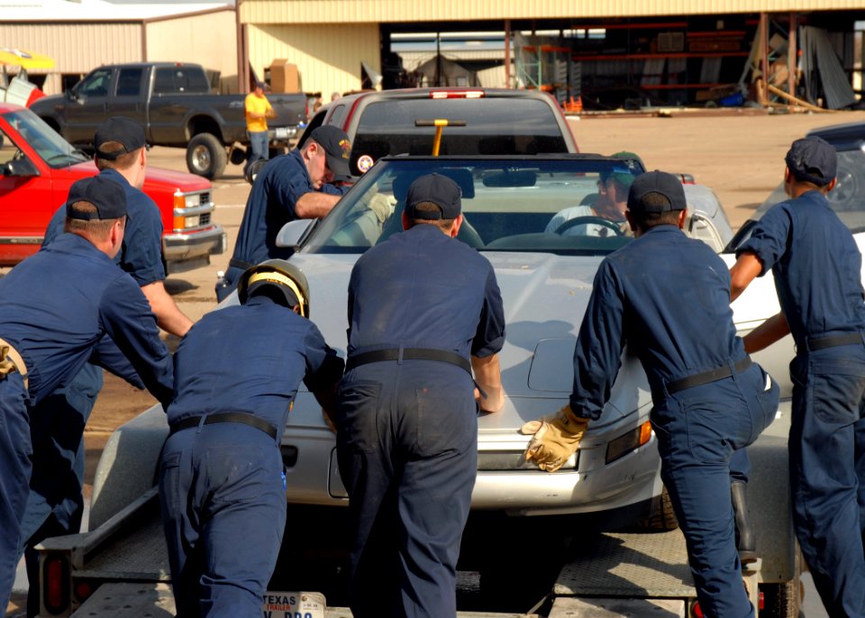US Navy 080922-N-2838W-004 Sailors help a Galveston, Texas, resident load his damaged car onto a trailer to be transported for repairs