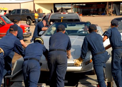 US Navy 080922-N-2838W-004 Sailors help a Galveston, Texas, resident load his damaged car onto a trailer to be transported for repairs