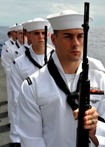 US Navy 080921-N-1745W-109 Members of the aircraft carrier USS Abraham Lincoln (CVN 72) honor guard stand at parade rest during a burial at sea for nine former service members
