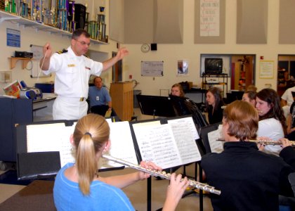 US Navy 080923-N-4649C-007 Lt.j.g. Patrick Sweeten conducts a music class at McNary High School photo