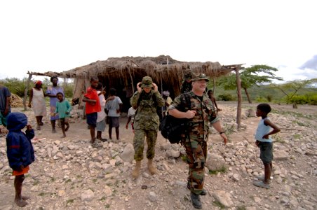 US Navy 080924-N-9620B-004 Cmdr. Dale Bates, of the U.S. Public Health Service, and Canadian Army Lt. Sophie Lavoie, both assigned to the amphibious assault ship USS Kearsarge (LHD 3), assess the condition of a village