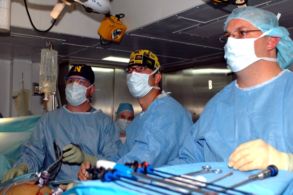 US Navy 080924-N-9950J-072 Lt. Michael Barna, Lt. Timothy Platz, and Hospital Corpsman 2nd Class James Hubbs, , perform an emergency appendectomy
