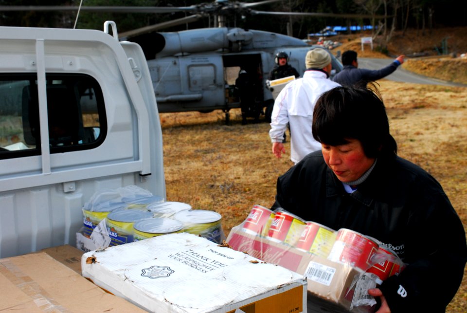US Navy 110322-N-SB672-309 A Japanese woman loads humanitarian assistance supplies onto her truck