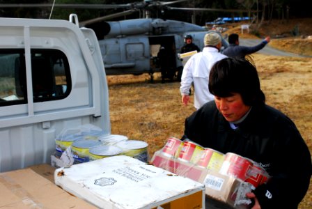 US Navy 110322-N-SB672-309 A Japanese woman loads humanitarian assistance supplies onto her truck