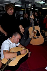 US Navy 080924-N-4005H-148 Scott Stapp signs a guitar for a Sailor photo