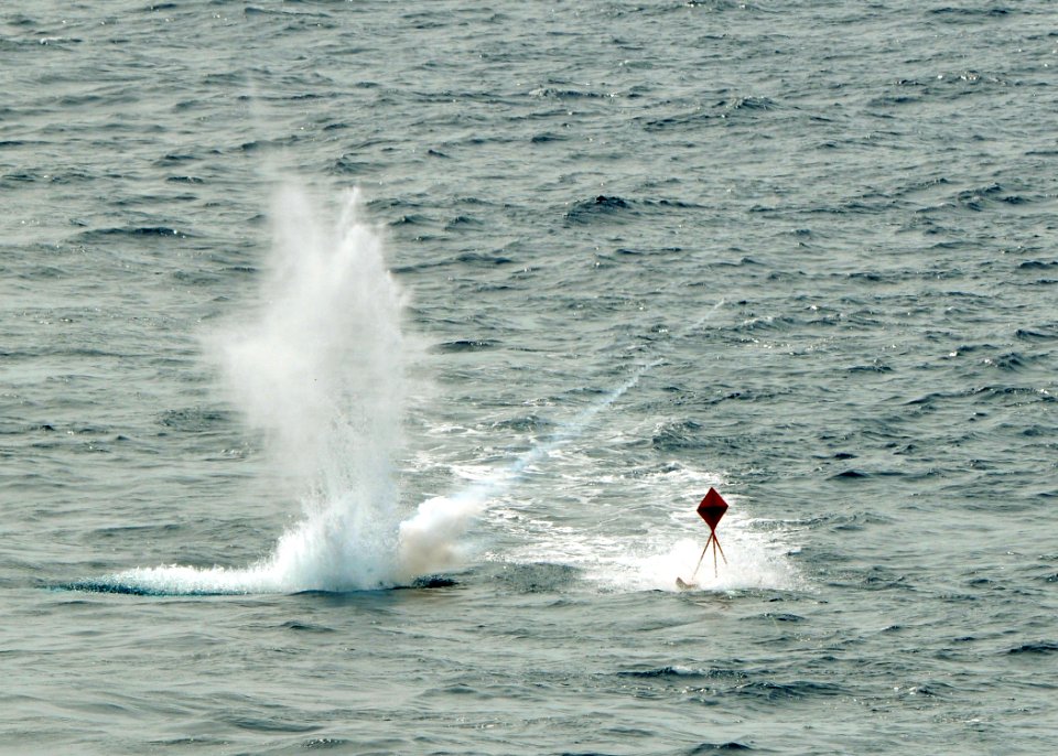 US Navy 080922-N-7981E-083 MK-76 low-drag practice munitions impact near a target being towed behind the Nimitz-class aircraft carrier USS Abraham Lincoln (CVN 72).