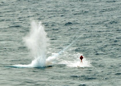 US Navy 080922-N-7981E-083 MK-76 low-drag practice munitions impact near a target being towed behind the Nimitz-class aircraft carrier USS Abraham Lincoln (CVN 72).
