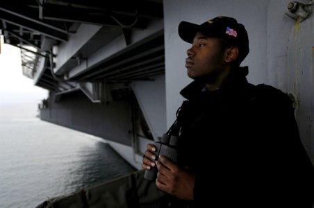 US Navy 080927-N-4954I-004 Seaman Marshall Everett mans the starboard lookout as the Nimitz-class aircraft carrier USS John C. Stennis (CVN 74) begins her entrance into Coronado Bay for a scheduled port visit