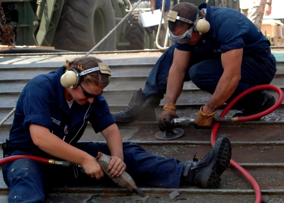 US Navy 080925-N-9134V-062 Boatswain's Mate Seaman Jaclyn George and Seaman Wade Pritchard grind rust off the flight deck ramp
