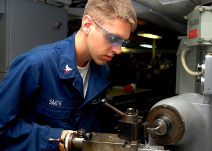 US Navy 080923-N-2456S-032 Machinery Repairman 3rd Class Bryan Smith uses a Lathe to make hammer handles