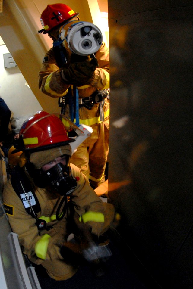 US Navy 080925-N-4856C-019 Firefighters respond to a simulated fire during a general quarters drill